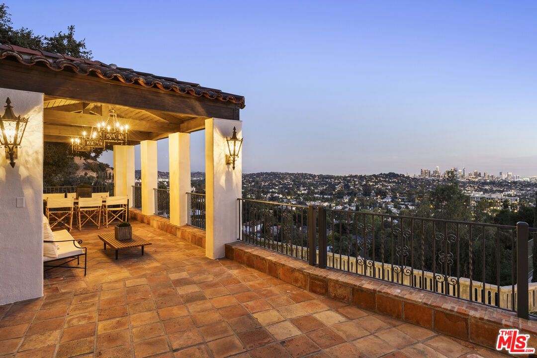 4565 Dundee Drive Los Angeles, CA 90027 - Photo 26 of 42 a view of a balcony with chairs and iron fence