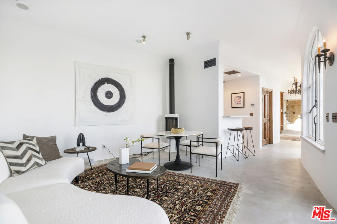 4565 Dundee Drive Los Angeles, CA 90027 - Photo 30 of 42 a living room with furniture a clock and a table