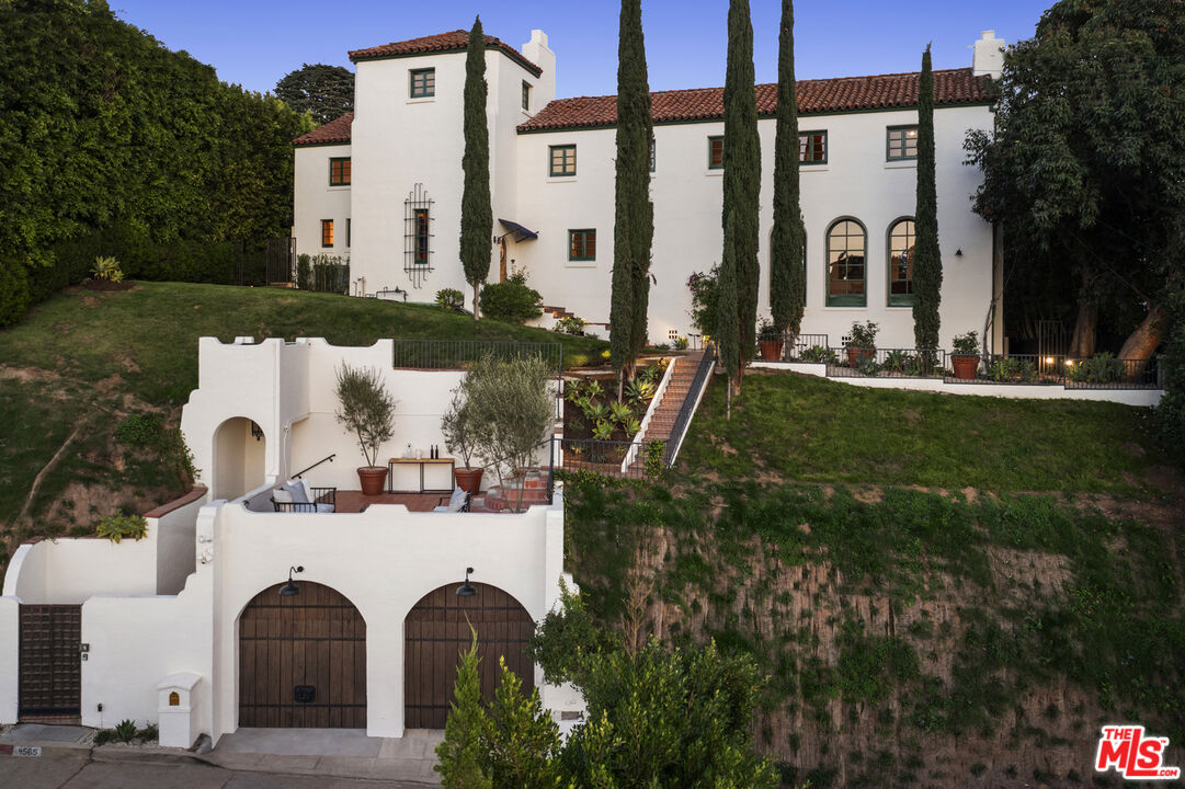 4565 Dundee Drive Los Angeles, CA 90027 - Photo 3 of 42 a view of a white house with a yard