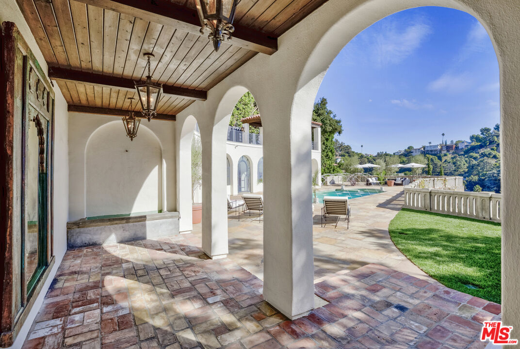 4565 Dundee Drive Los Angeles, CA 90027 - Photo 36 of 42 a view of a porch with a floor to ceiling window and wooden fence