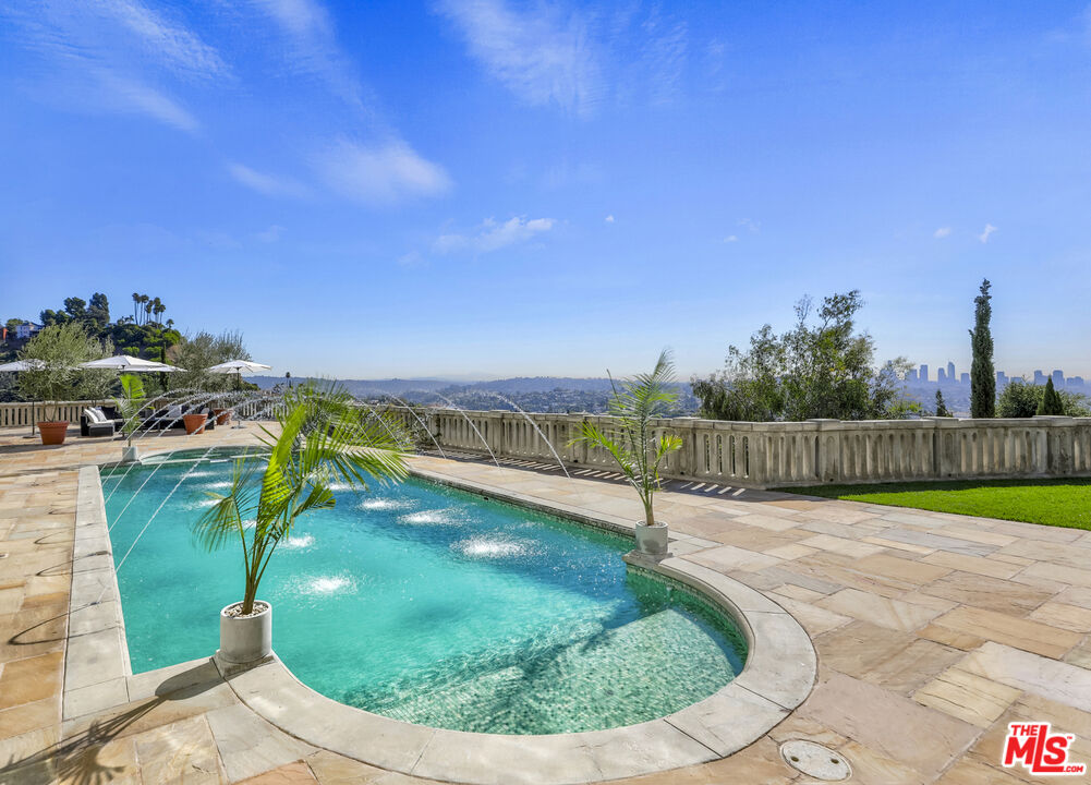 4565 Dundee Drive Los Angeles, CA 90027 - Photo 38 of 42 a view of a swimming pool with a yard