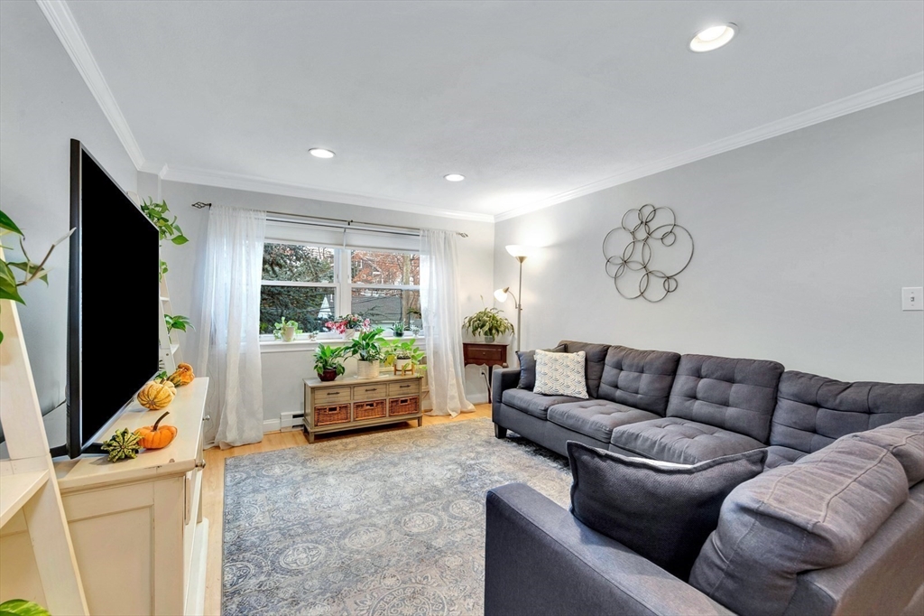 588 Main Street, Unit 3C Stoneham, MA 02180 - Photo 14 of 24 a living room with furniture and a flat screen tv
