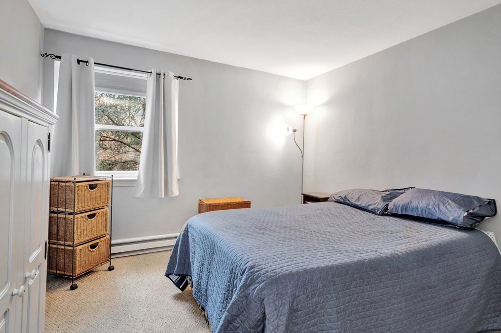 588 Main Street, Unit 3C Stoneham, MA 02180 - Photo 19 of 24 a bedroom with a bed and a window