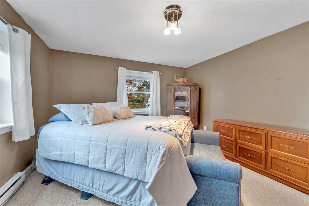 588 Main Street, Unit 3C Stoneham, MA 02180 - Photo 20 of 24 a bedroom with a bed and wooden floor