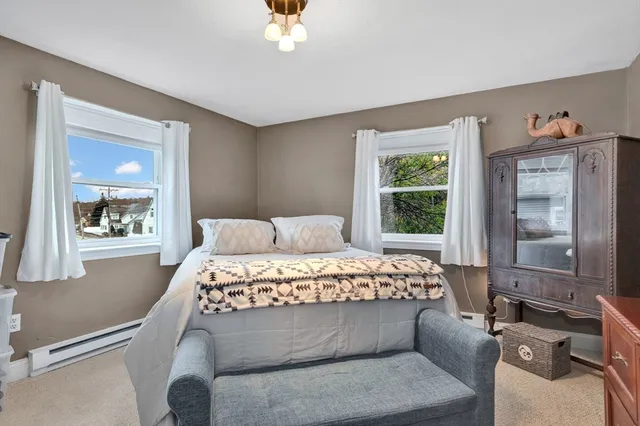 a bed sitting in a bedroom next to a window