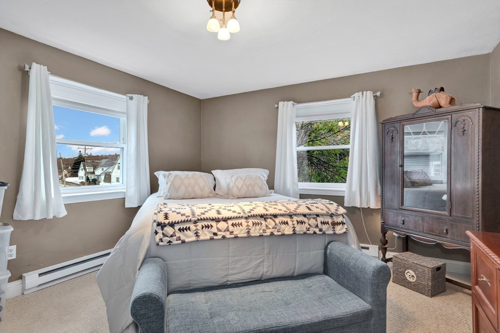 588 Main Street, Unit 3C Stoneham, MA 02180 - Photo 21 of 24 a bed sitting in a bedroom next to a window