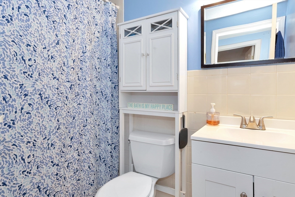 588 Main Street, Unit 3C Stoneham, MA 02180 - Photo 22 of 24 a bathroom with a sink and a toilet