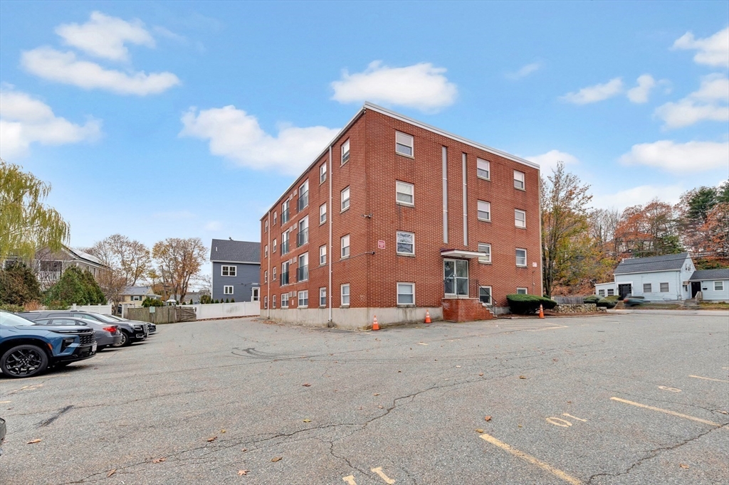 588 Main Street, Unit 3C Stoneham, MA 02180 - Photo 4 of 24 a view of a street with cars