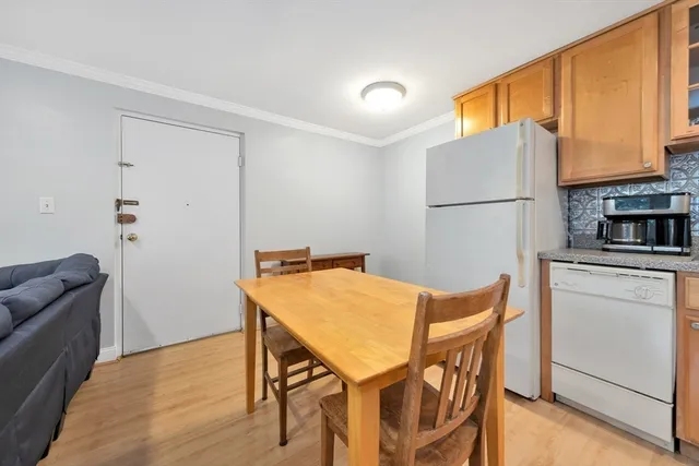 a view of kitchen with stainless steel appliances cabinets and wooden floor