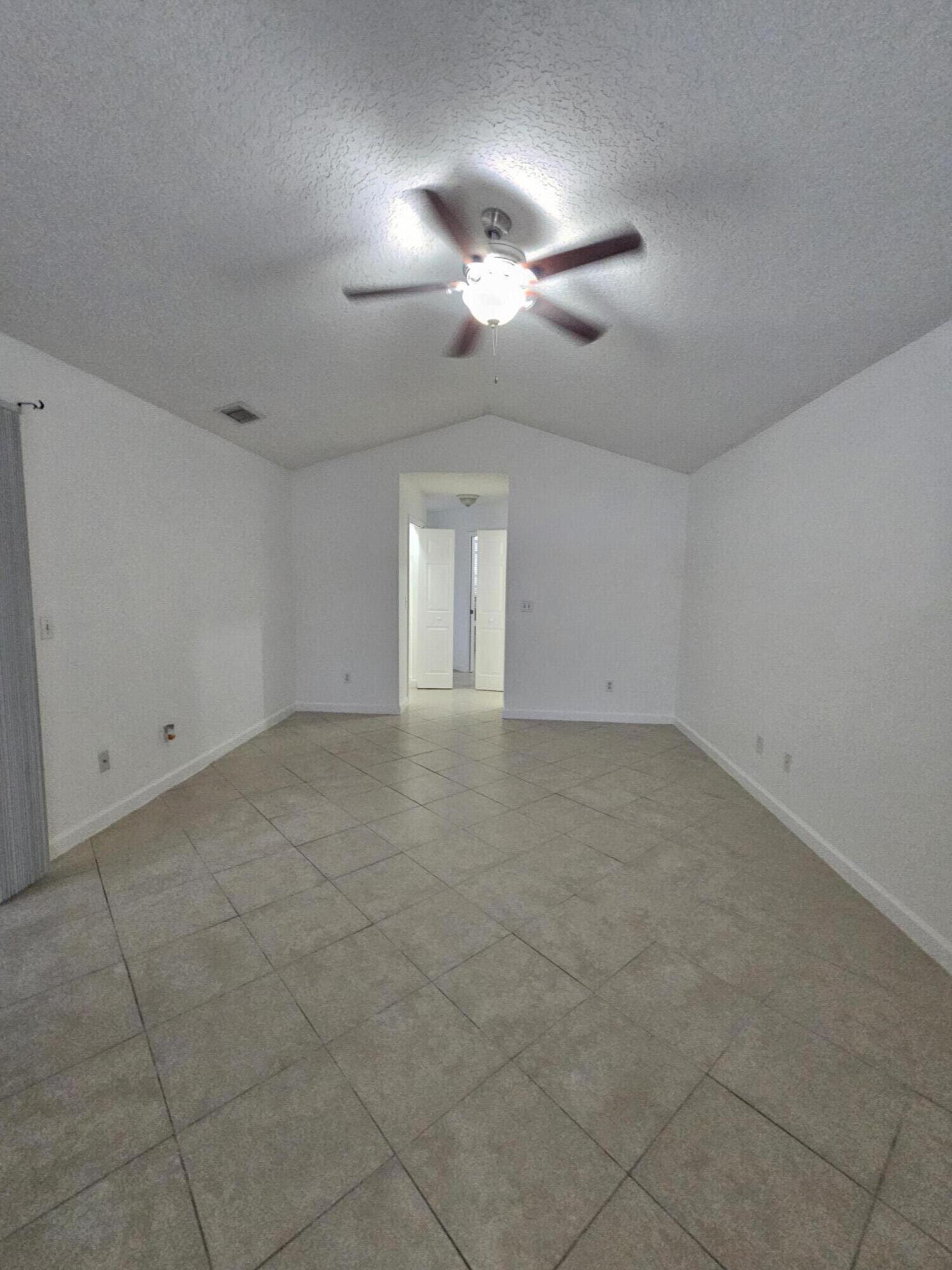 3215 Southeast Pinto Street Port St. Lucie, FL 34984 - Photo 11 of 34 en empty room with ceiling fan and window