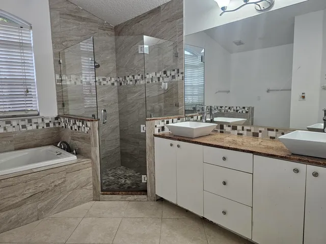 a bathroom with a bathtub and shower