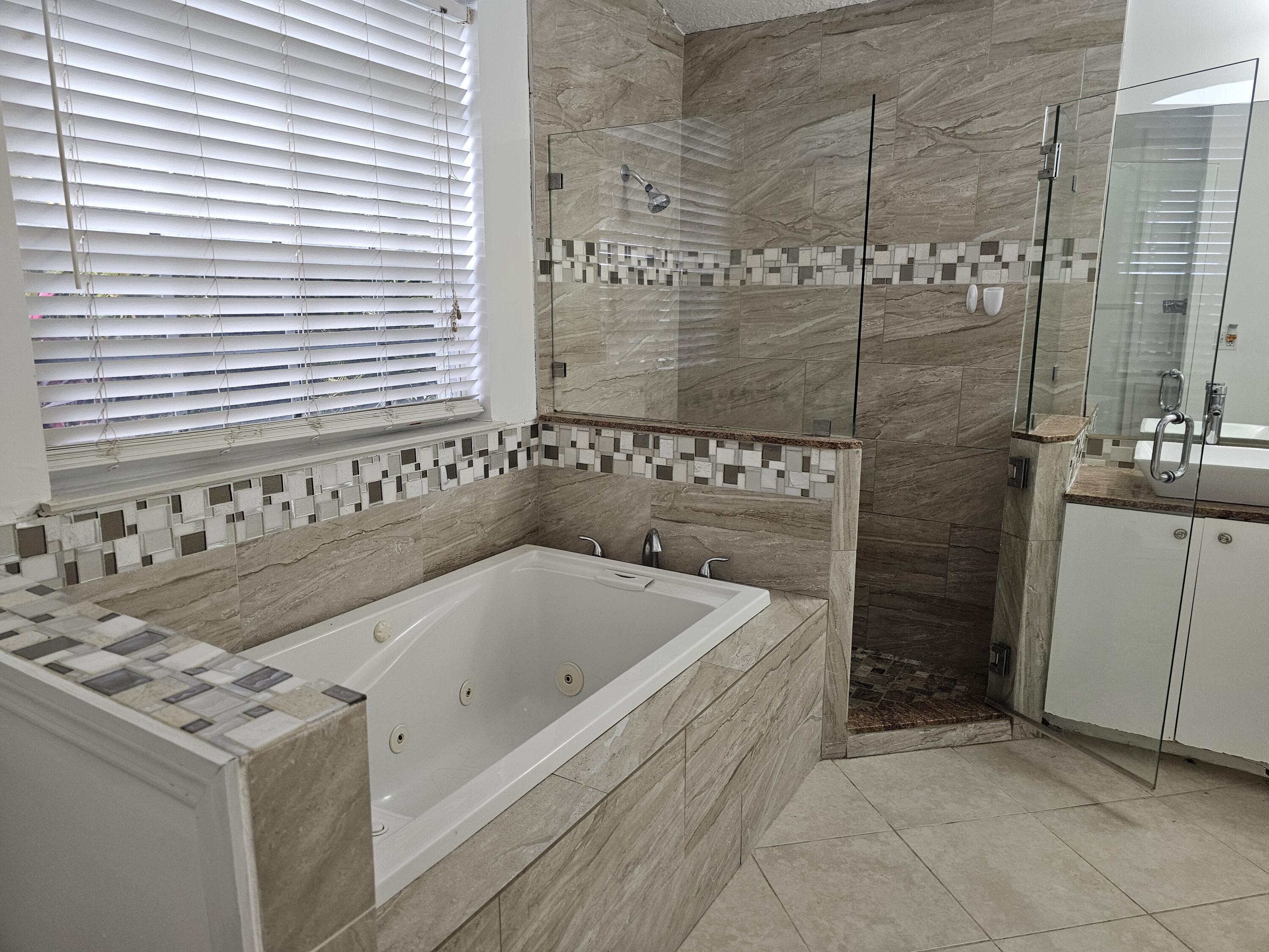 3215 Southeast Pinto Street Port St. Lucie, FL 34984 - Photo 16 of 34 a bathroom with a bathtub and shower