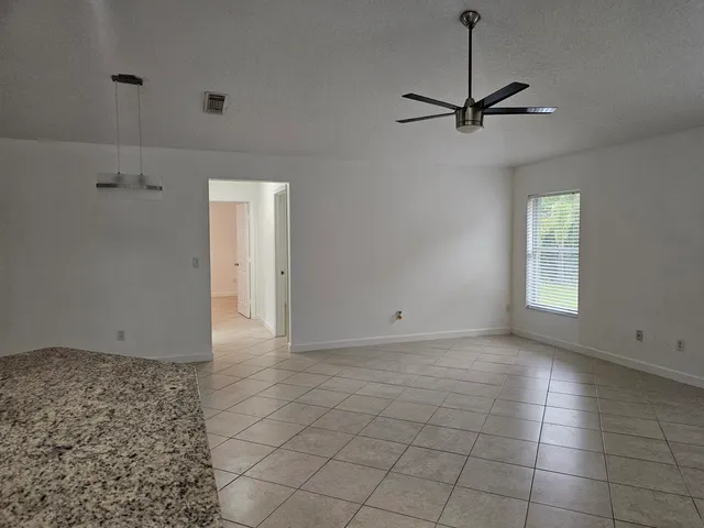 a kitchen with kitchen island granite countertop a sink appliances and cabinets