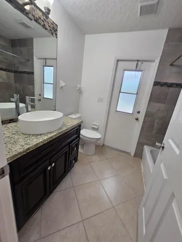 a bathroom with a tub a sink and a shower