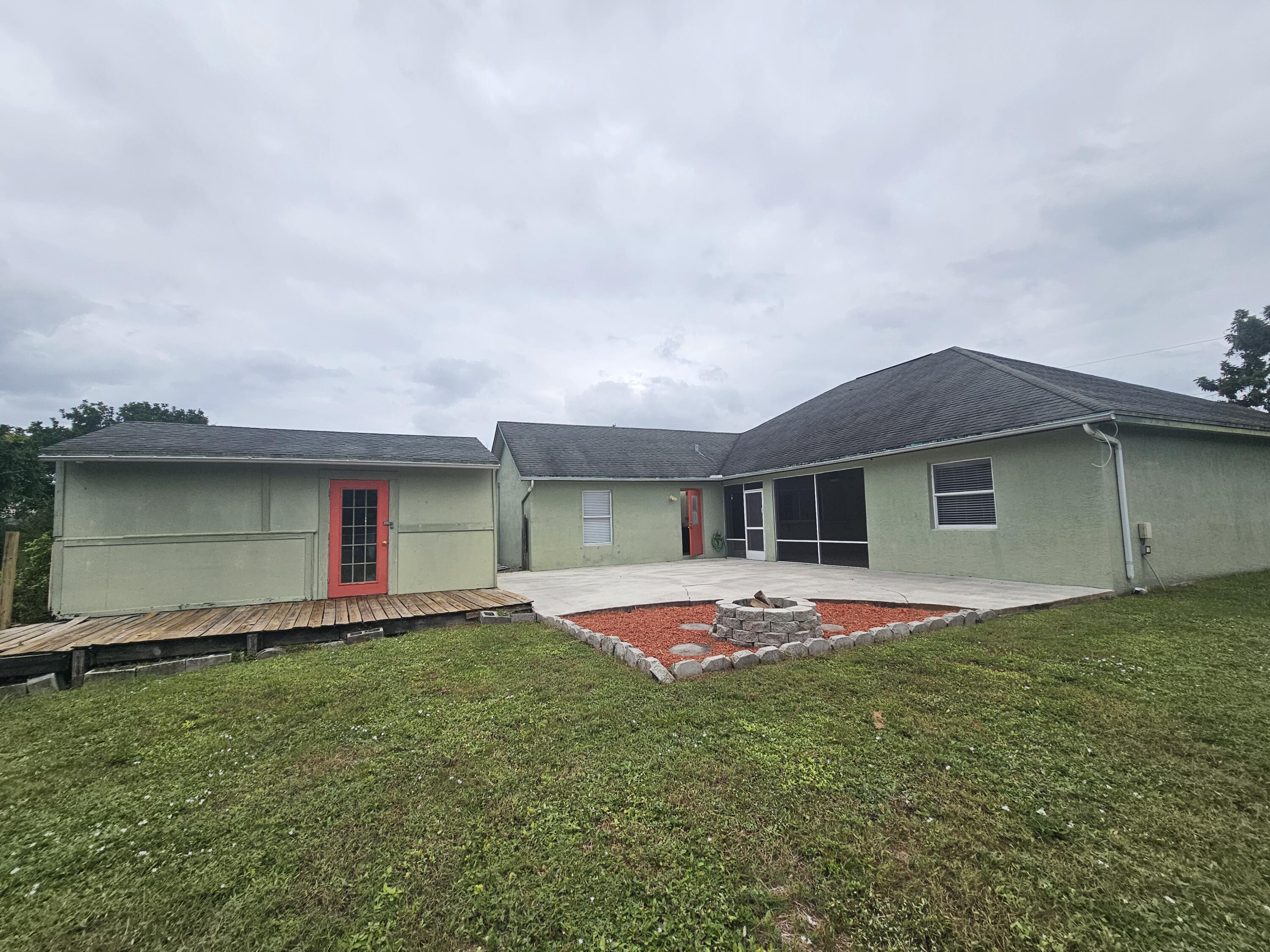 3215 Southeast Pinto Street Port St. Lucie, FL 34984 - Photo 28 of 34 a front view of house with yard and trees