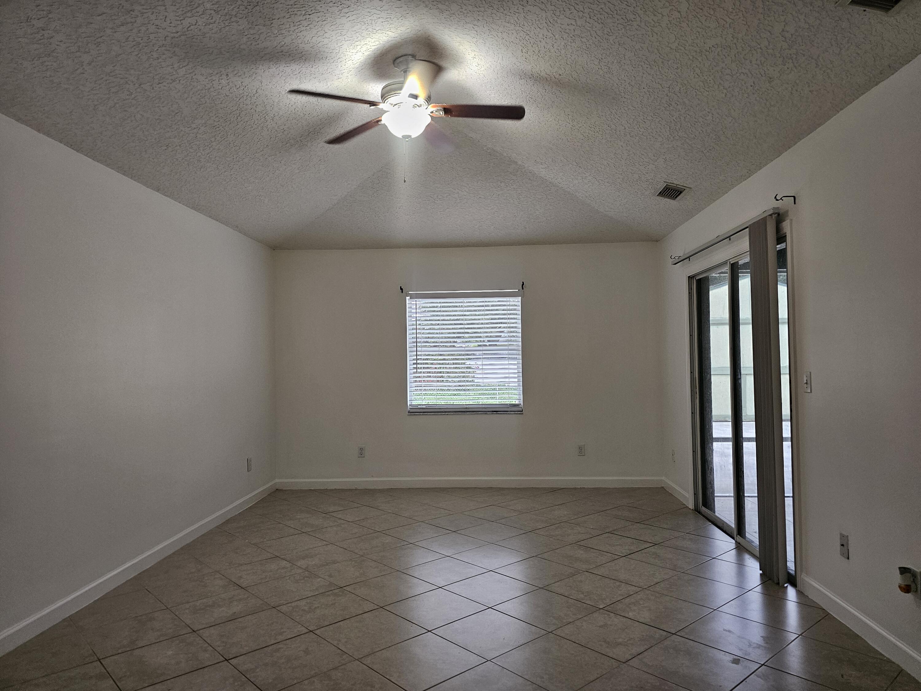 3215 Southeast Pinto Street Port St. Lucie, FL 34984 - Photo 10 of 34 a view of an empty room with a window