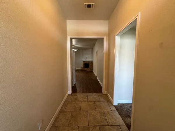 a view of a hallway view with wooden floor and staircase
