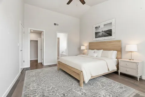 a bedroom with a bed and a painting on the wall