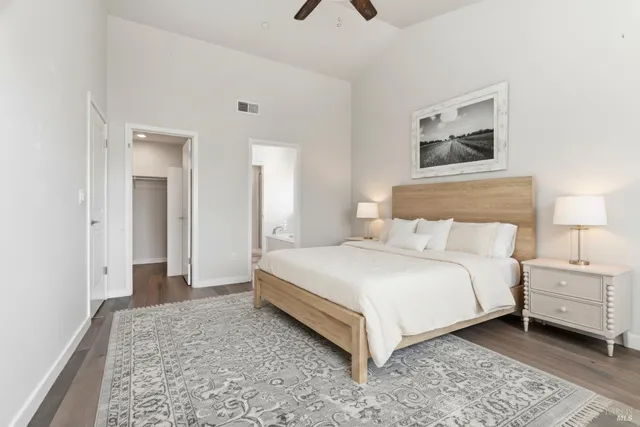 a bedroom with a bed and a painting on the wall