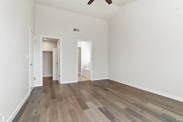 a view of an empty room with wooden floor
