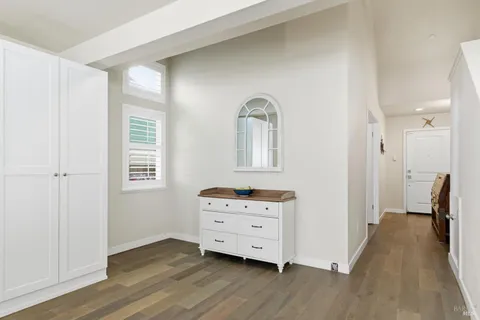 a view of a bedroom with furniture and wooden floor