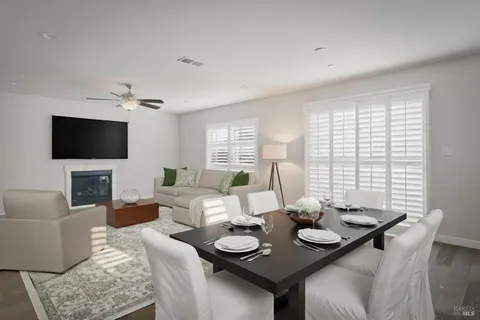 a living room with couches a coffee table and a flat screen tv