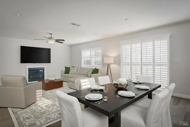 a living room with couches a coffee table and a flat screen tv