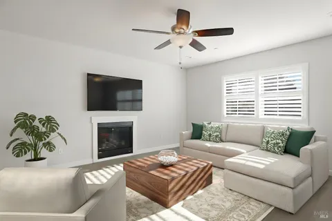 a living room with furniture a window and a fireplace