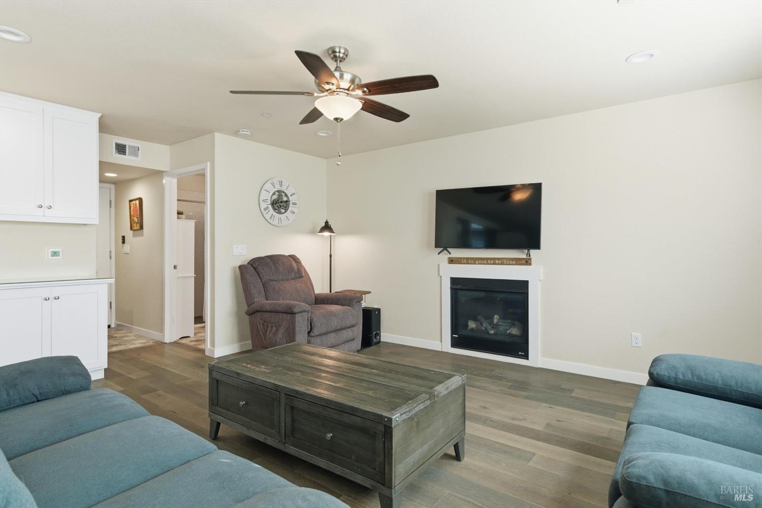 3769 Mocha Lane Santa Rosa, CA 95403 - Photo 10 of 38 a living room with furniture a fireplace and a flat screen tv