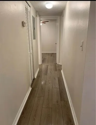 a view of a hallway with wooden floor