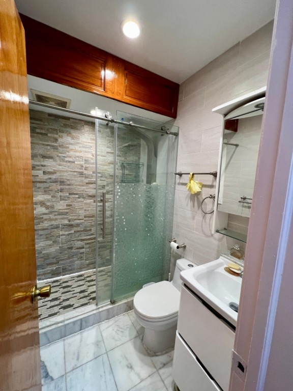1114 Bay Ridge Parkway Brooklyn, NY 11228 - Photo 6 of 7 a bathroom with a toilet a sink and shower