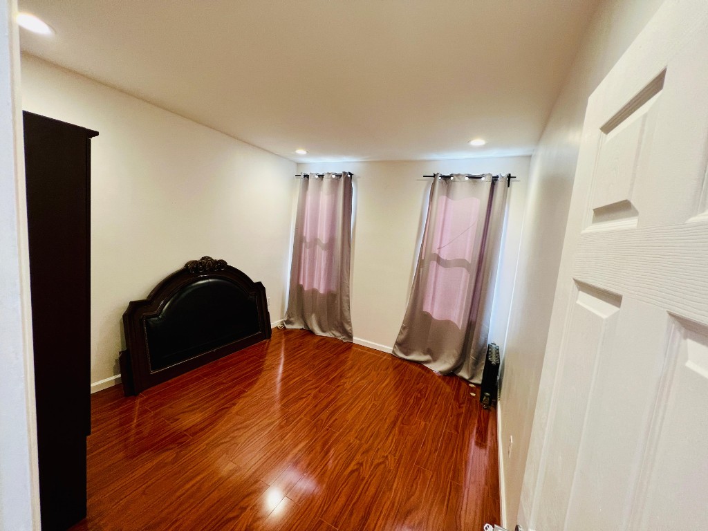 1114 Bay Ridge Parkway Brooklyn, NY 11228 - Photo 7 of 7 a view of a room with wooden floor and a window