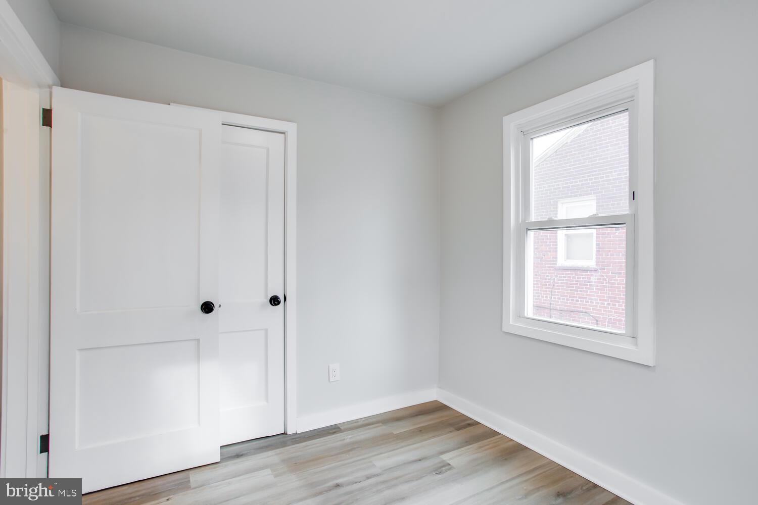 4803 Bass Place Southeast Washington, DC 20019 - Photo 16 of 22 a view of an empty room with wooden floor and a window