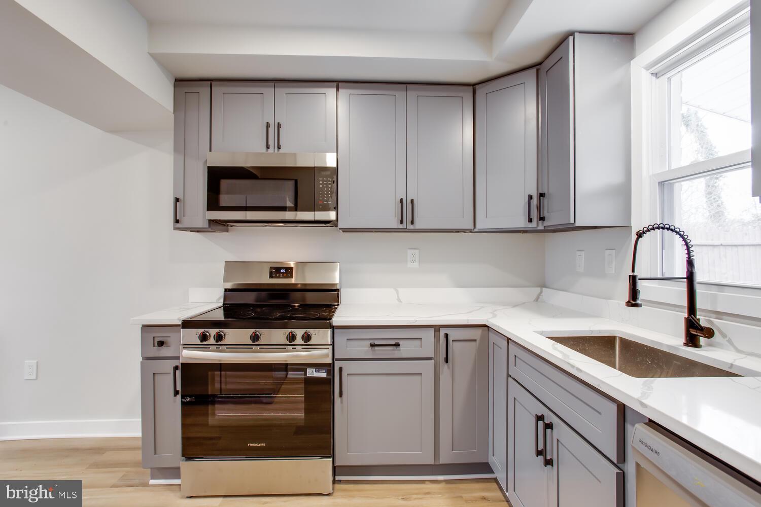 4803 Bass Place Southeast Washington, DC 20019 - Photo 9 of 22 a kitchen with cabinets stainless steel appliances and a sink