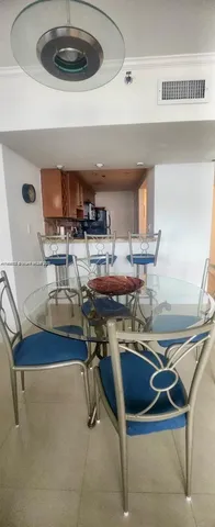 a kitchen with a sink a stove and chairs