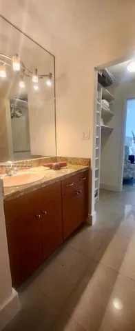 a bathroom with a sink double vanity and a mirror