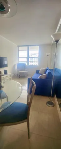 a living room with a bed furniture and a window