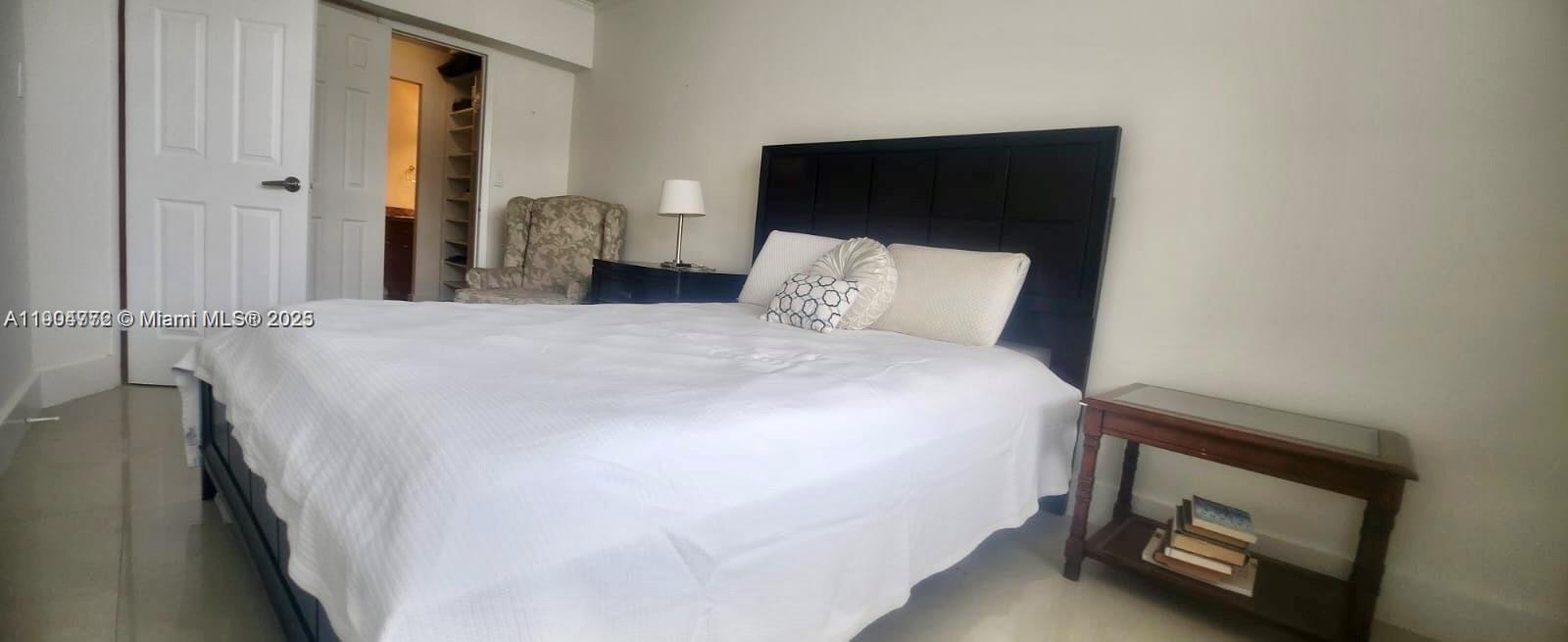 100 Lincoln Road, Unit 1626 Miami Beach, FL 33139 - Photo 3 of 43 a bed sitting in a bedroom next to a window with a tv