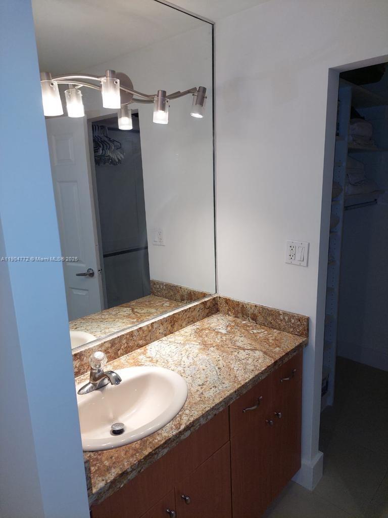 100 Lincoln Road, Unit 1626 Miami Beach, FL 33139 - Photo 8 of 43 a bathroom with a granite countertop sink and a mirror