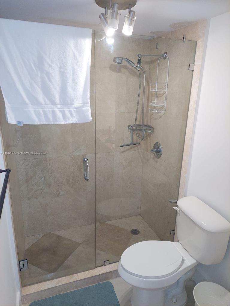 100 Lincoln Road, Unit 1626 Miami Beach, FL 33139 - Photo 9 of 43 a white toilet sitting next to a shower