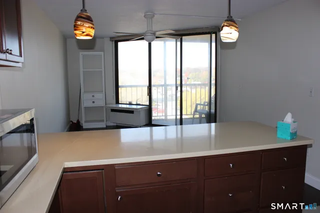 a kitchen with a sink a counter space and a window