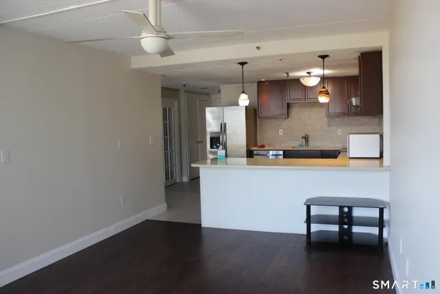 a kitchen with stainless steel appliances granite countertop a refrigerator and a sink