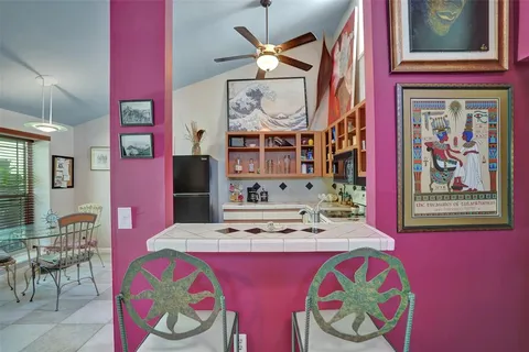 a bedroom with a bed and a painting on the wall