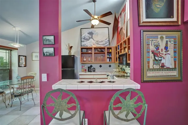 a bedroom with a bed and a painting on the wall