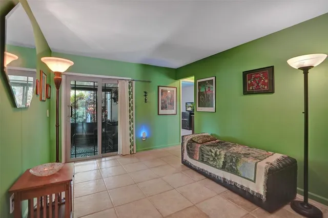 a living room with furniture and a baby crib