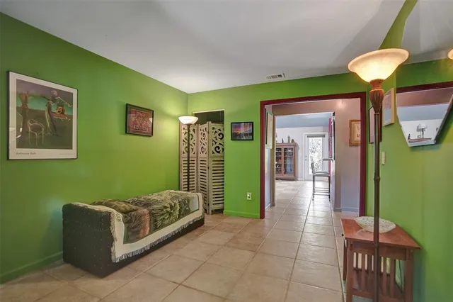 a bedroom with a bed a table and chair