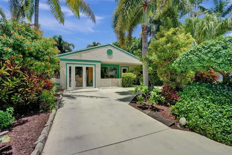 a view of a house with potted plants