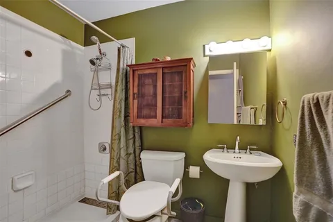 an empty room with window and ceiling fan