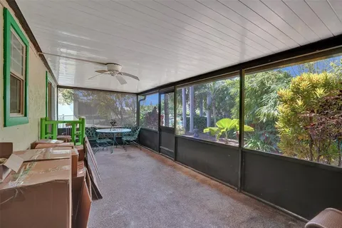 a living room with furniture and large windows
