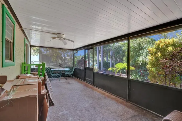 a living room with furniture and large windows